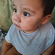 Bryson joined the competition — help win amazing prizes! baby, child, infant, bib, clothing, sitting, skin, face, eyes, hands, cute, portrait, indoor, young, person, soft, expression, closeup, comfortable, curious
