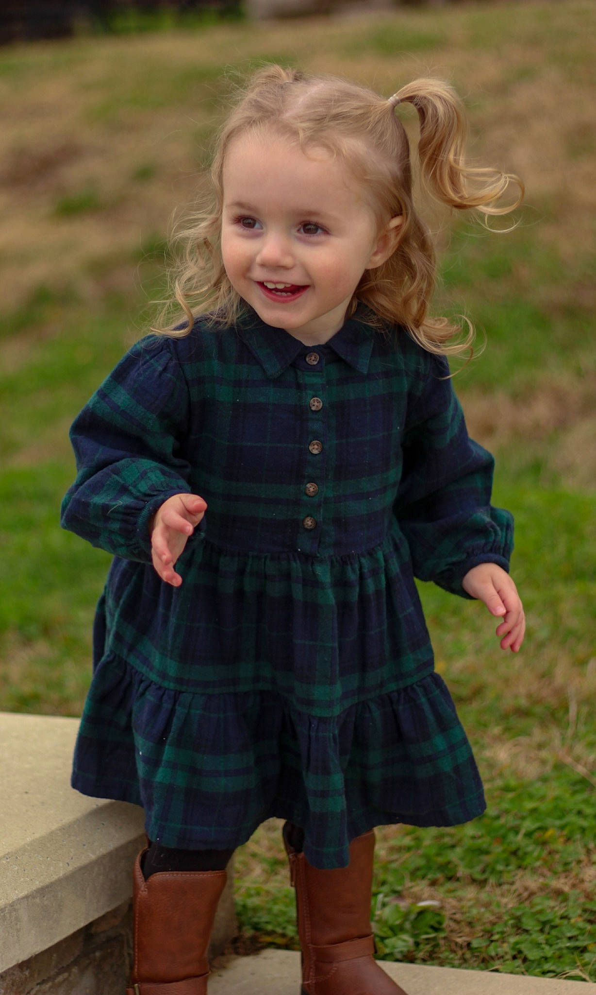 Maisyn is registered to the contest to win money with this photo: baby_toddler_clothing, child, eye, face, grass, hair, happy, head, joy, one_piece_garment, outerwear, people_in_nature, person, photograph, plaid, plant, sleeve, smile, standing, summer