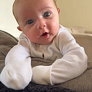 Elliot joined the competition — help win amazing prizes! baby, infant, face, eyes, white_clothing, pajamas, indoor, couch, blanket, curious, expression, skin, head, arm, soft_lighting, home, person, portrait, young_child, cozy