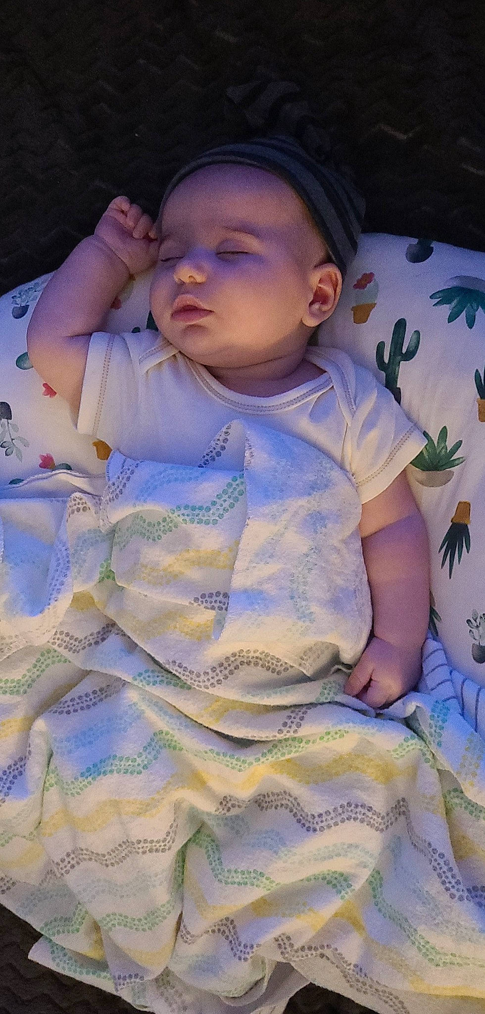 Solomon is registered to the contest to win money with this photo: arm, baby, baby_toddler_clothing, cheek, dress, eye, facial_expression, happy, headgear, iris, lip, mouth, nose, person, pink, purple, skin, sleeve, sun_hat, textile