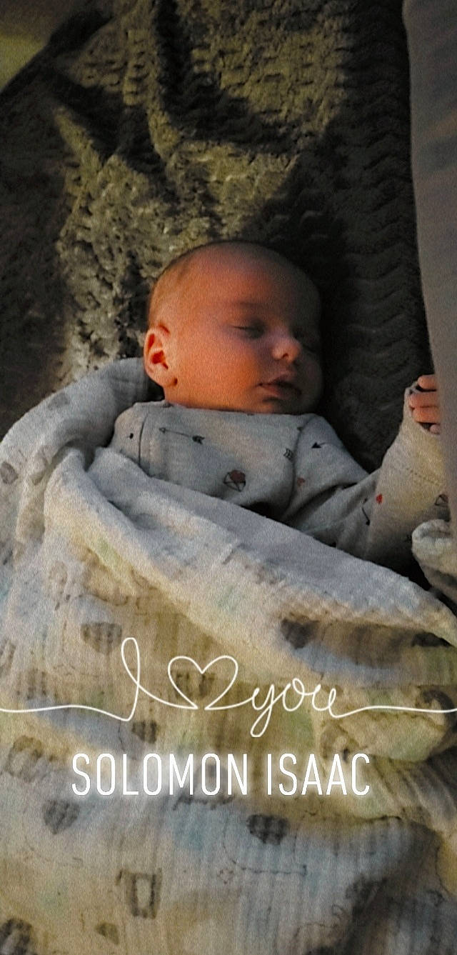 Solomon is registered to the contest to win money with this photo: adaptation, baby, child, comfort, facial_expression, font, fur, grass, happy, linens, morning, nose, person, photo_caption, plant, sitting, skin, textile, toddler, tree