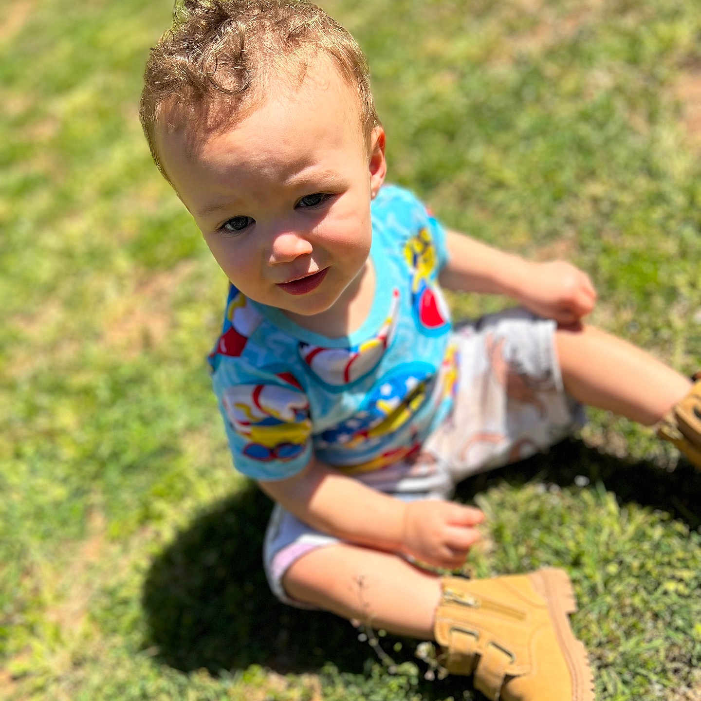 Tobias is registered to the contest to win money with this photo: baby, baseball, baseballglove, clothing, face, footwear, glove, grass, head, lawn, outdoors, people, person, photography, plant, portrait, shoe, shorts, sitting, sport