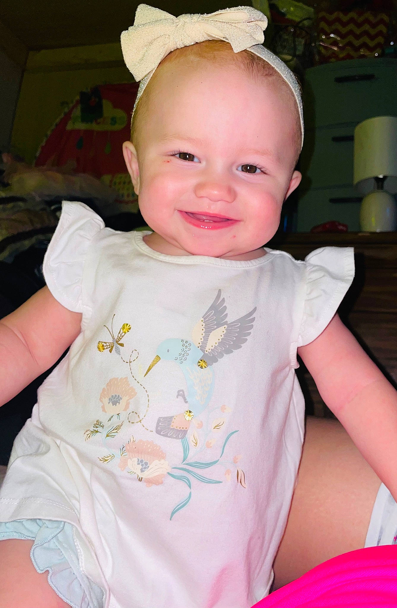 Irissa is registered to the contest to win money with this photo: baby, baby_toddler_clothing, beauty, cheek, child, costume_hat, eye, face, happy, head, headband, iris, joy, person, pink, sitting, skin, sleeve, smile, t_shirt