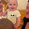 baby, child, smile, polka_dot, shirt, indoor, staircase, wood, railing, lights, family, adult, holding, happy, portrait, face, skin, people, candid, toddler