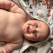 Sterlin joined the competition — help win amazing prizes! baby, smiling, towel, hood, ears, blanket, animal_pattern, cute, chubby, teeth, infant, lying_down, skin, blue_eyes, happy, soft_texture, cozy, child, portrait, indoors