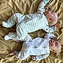 baby, sleeping, infant, onesie, blanket, bedroom, peaceful, cute, child, soft, patterned_clothing, two_babies, indoors, resting, newborn, face, skin, head, comfort, lying_down