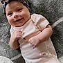 baby, smiling, headband, pink_onesie, dragonfly_print, blanket, soft_texture, infant, happy, cute, portrait, lying_down, child, face, fist, skin, indoor, closeup, adorable, person