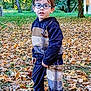 autumn, boy, casual, child, clothing, curious, fall, footwear, glasses, greenery, leaves, nature, outdoor, park, person, playground, shoes, smile, trees, young