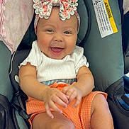 Jaslin joined the competition — help win amazing prizes! baby, child, smiling, car_seat, headband, bow, orange_shorts, white_shirt, blanket, happy, infant, socks, hands, face, seatbelt, indoors, cute, person, portrait, car