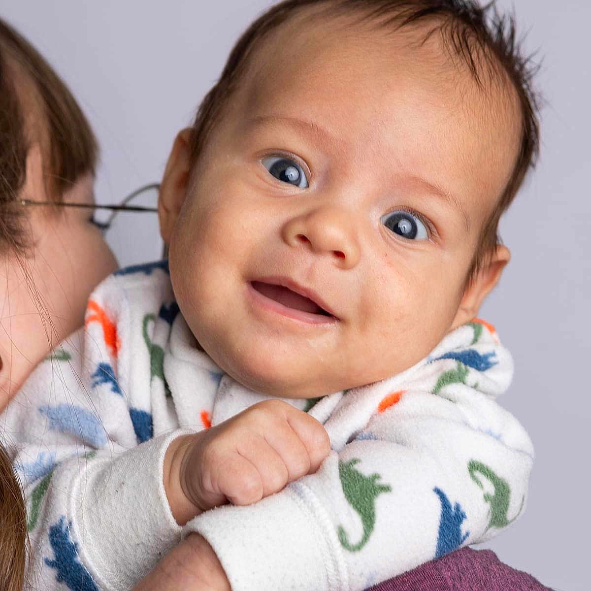 Charlie is registered to the contest to win money with this photo: accessories, baby, babylaughing, biting, face, glasses, happy, head, newborn, person, photography, portrait, smile