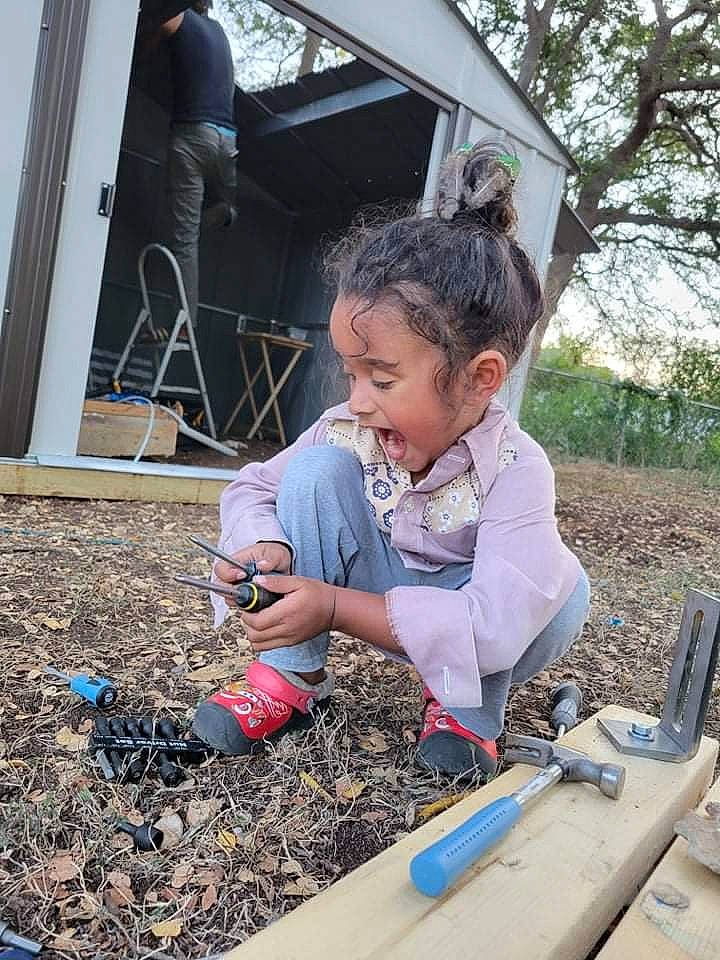 Ezekiel Jiraiya is registered to the contest to win money with this photo: child, city, fun, grass, landscape, leisure, outdoor_play_equipment, person, plant, play, recreation, sitting, sky, smile, soil, spring, t_shirt, toddler, tree, vertebrate