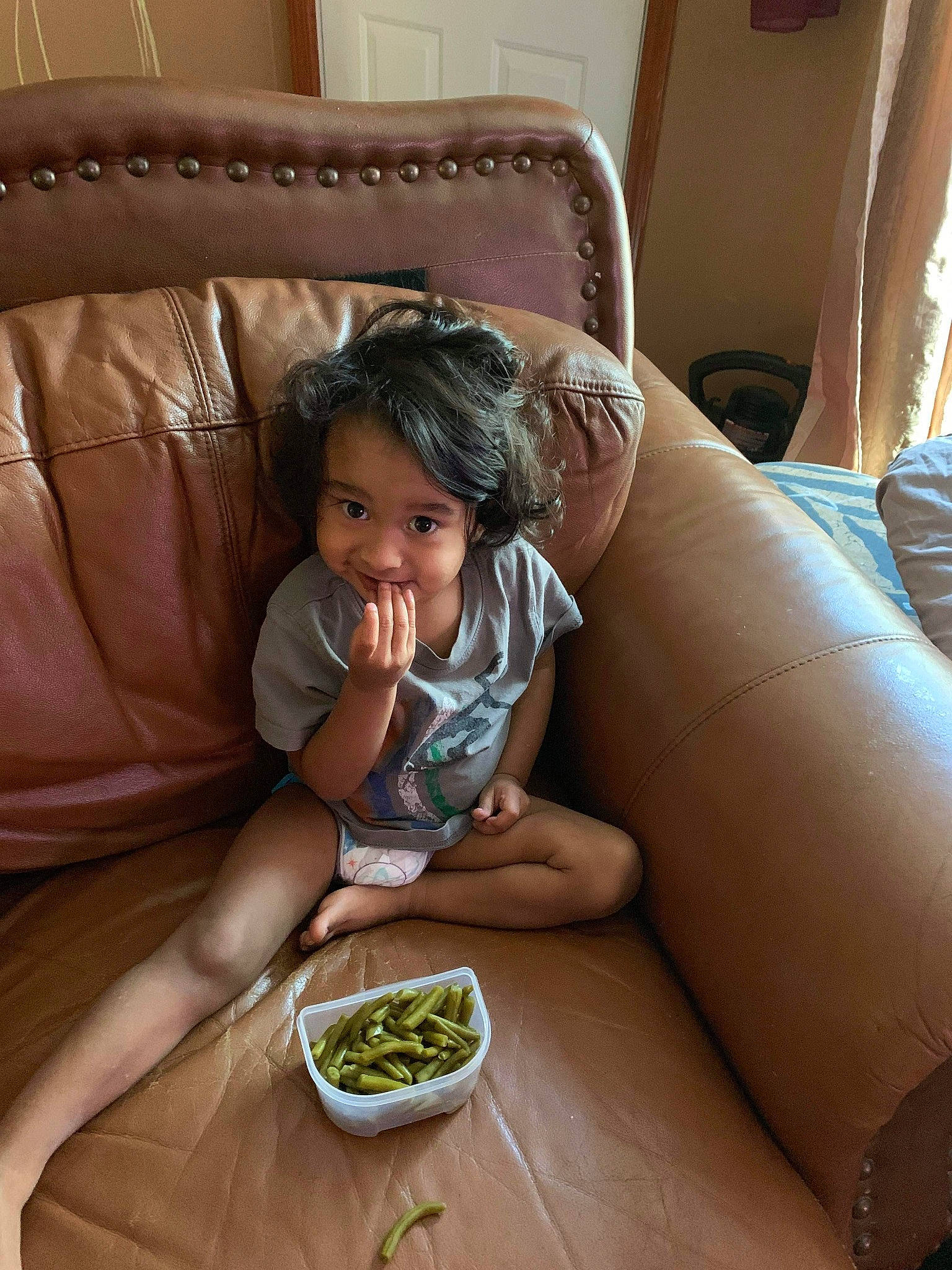 Ezekiel Jiraiya is registered to the contest to win money with this photo: child, comfort, comfort_food, couch, cuisine, dish, face, finger, flooring, food, ingredient, living_room, mixture, person, recipe, room, sitting, snapshot, tableware, toddler