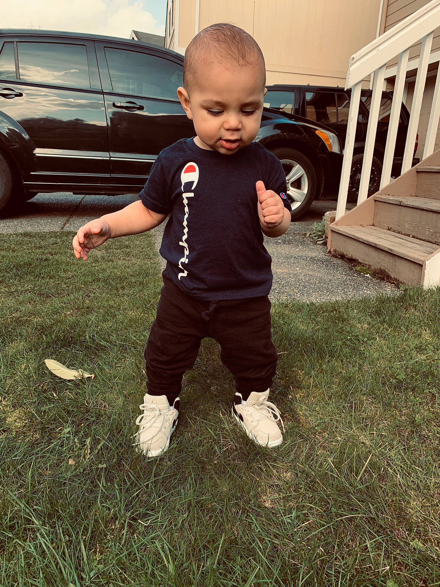 Taylen is registered to the contest to win money with this photo: arm, baby, car, child, cool, footwear, grass, head, leg, person, plant, shoe, shoulder, smile, standing, summer, t_shirt, toddler, vacation, vehicle