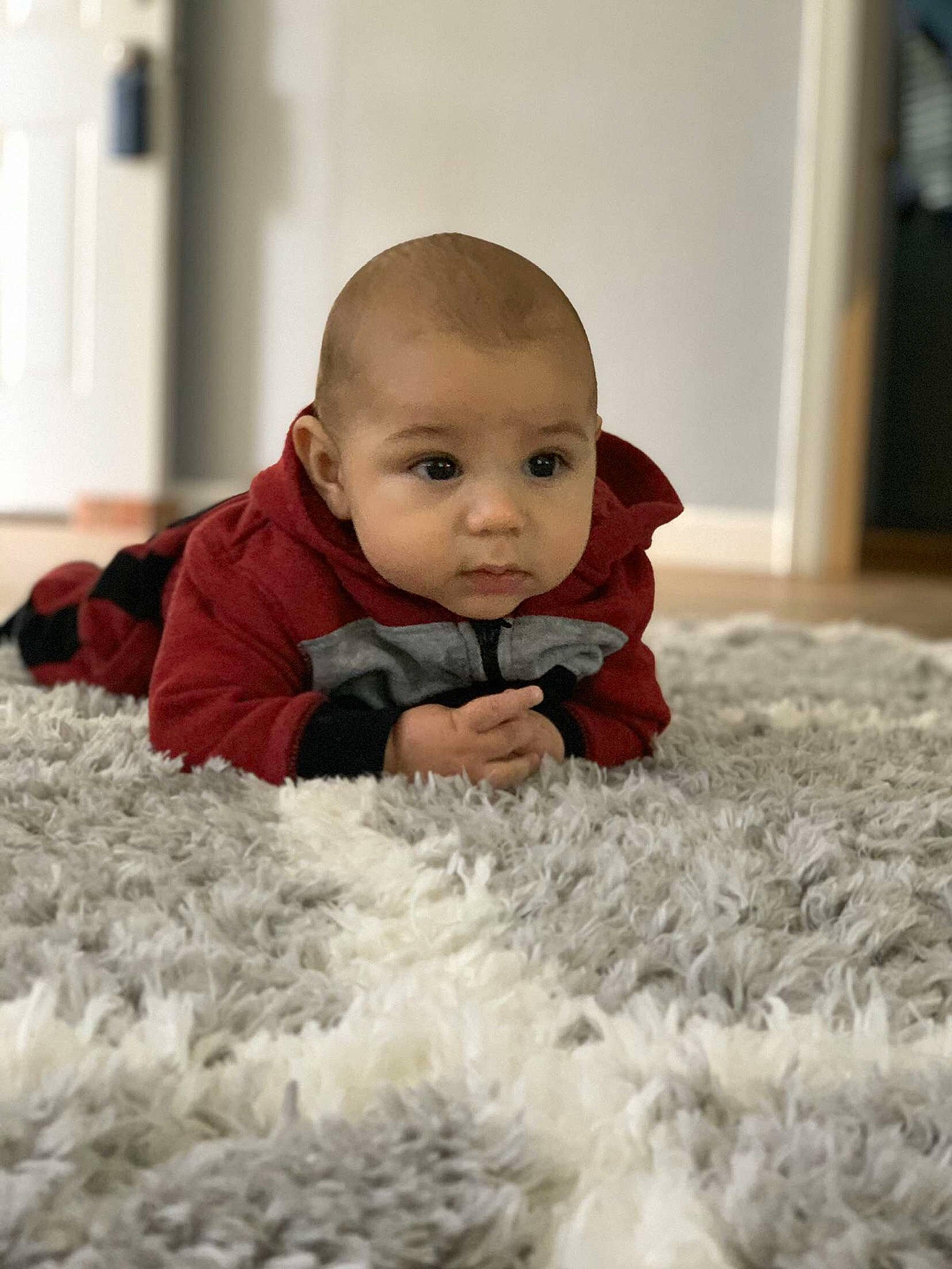 Taylen is registered to the contest to win money with this photo: baby, cheek, child, crawling, eye, face, flooring, fur, head, outerwear, people, person, photograph, photography, room, sitting, skin, sleeve, smile, toddler