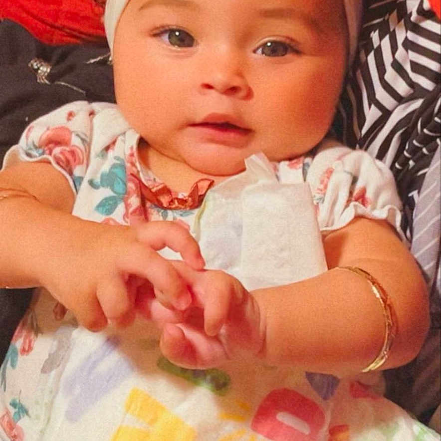 Janayla joined the competition — help win amazing prizes! adorable, baby, bracelet, child, closeup, colorful, curly_hair, cute, hands, headband, indoor, infant, patterned_clothing, person, playful, portrait, smiling, soft_lighting, toddler, young_child