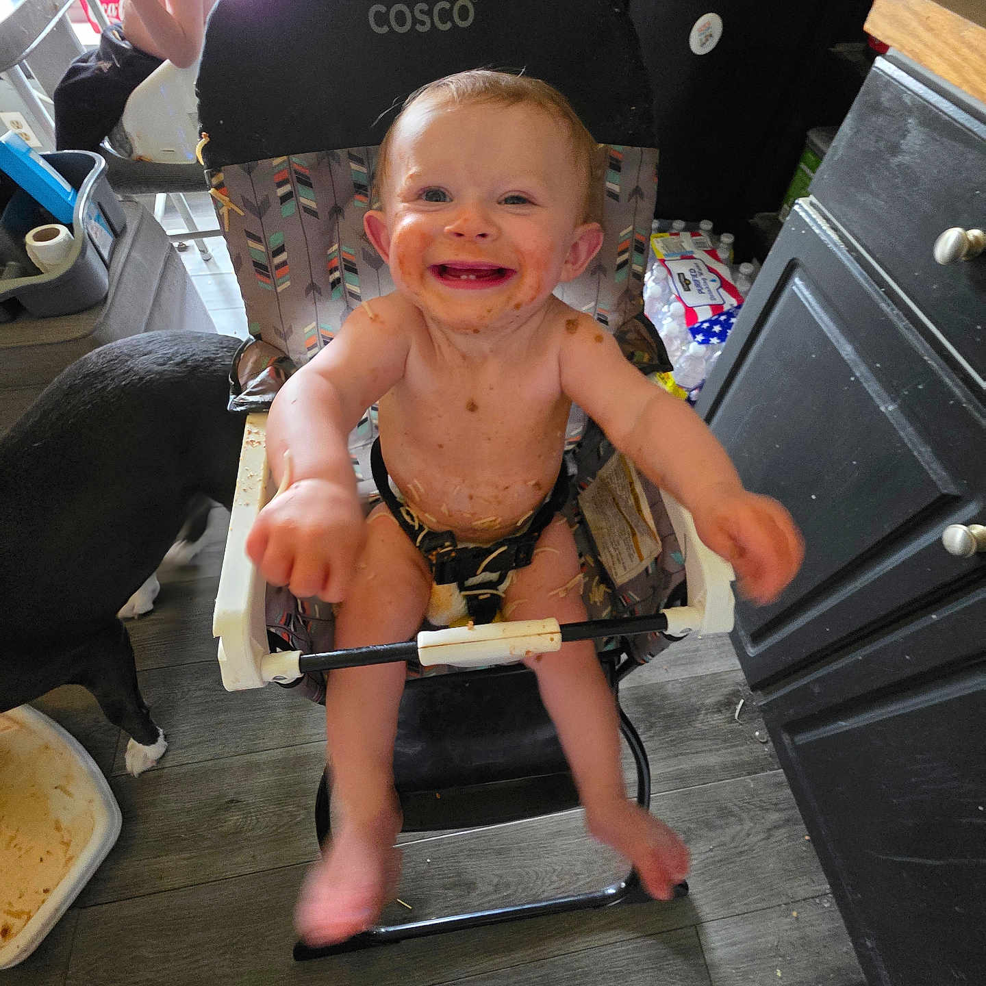 Emberlynn joined the competition — help win amazing prizes! arm_outstretched, baby, cabinet, child, dog, expression, floor, flooring, food, furniture, happy, high_chair, household, indoor, kitchen, messy, person, playful, smiling, toddler