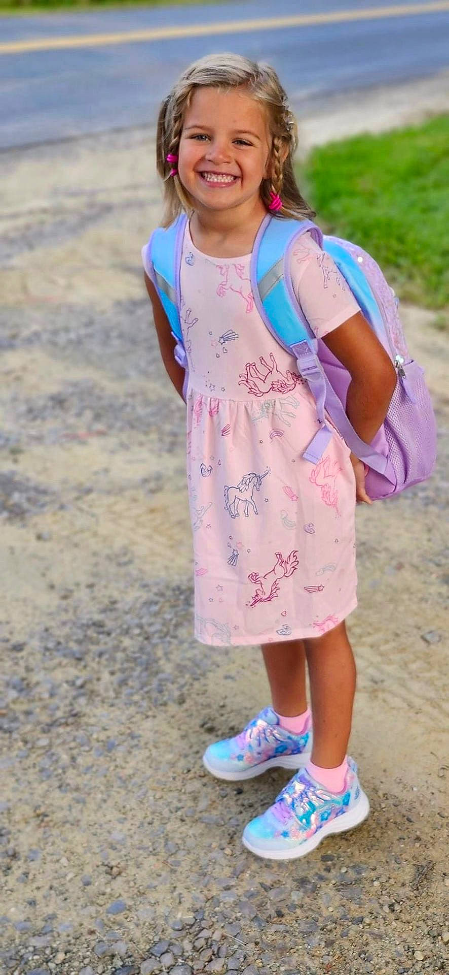 Maleanna is registered to the contest to win money with this photo: backpack, bag, child, city, clothing, dress, face, female, footwear, girl, head, outdoors, person, photography, portrait, road, shoe, sneaker, standing, walking