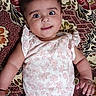 Yashfa joined the competition — help win amazing prizes! baby, infant, child, smiling, lying_down, floral_pattern, onesie, cute, happy, face, skin, hand, arm, head, eyes, fabric, pattern, textile, indoor, person
