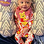 Jovanni is registered to the contest to win money with this photo: baby, infant, smiling, winnie_the_pooh, onesie, cushion, pattern, milestone, 4_months, face, person, child, cute, happy, indoor, portrait, clothing, sitting, colorful, fabric