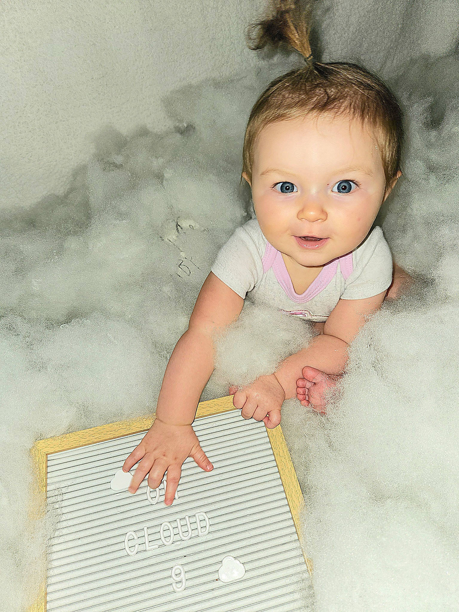 Adalyn is registered to the contest to win money with this photo: baby, baby_products, baby_toddler_clothing, cheek, child, comfort, flooring, hand, happy, pattern, people_in_nature, person, product, sitting, skin, sleeve, textile, thumb, toddler, wood