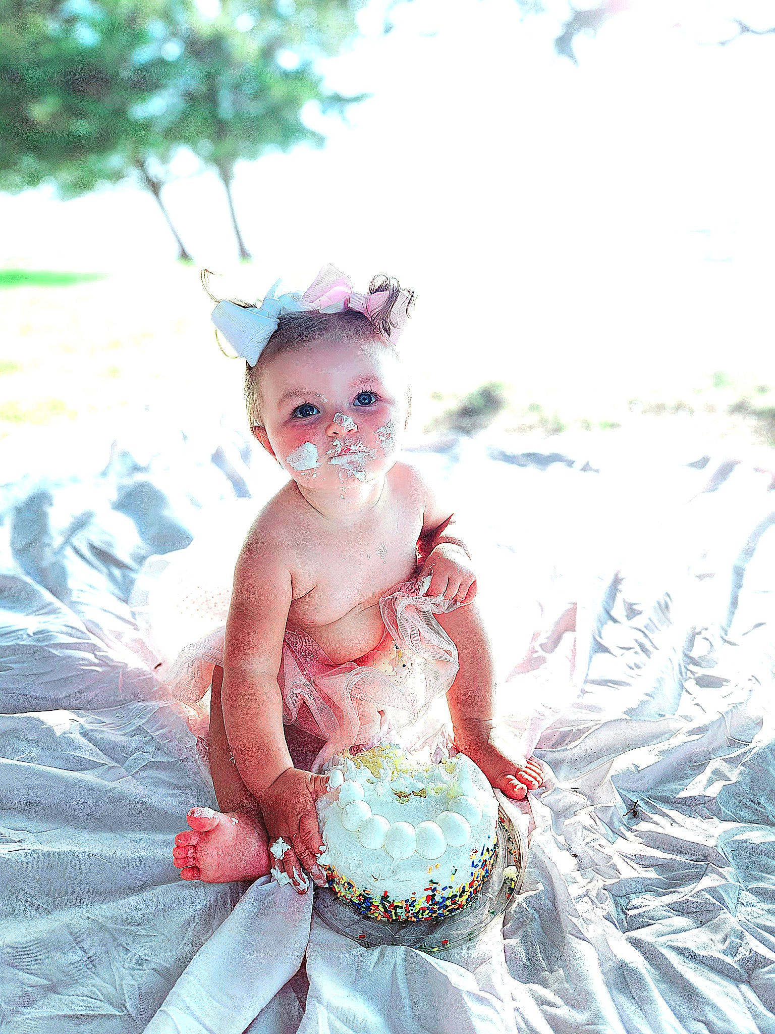 Adalyn is registered to the contest to win money with this photo: abdomen, baby, baby_toddler_clothing, child, costume, event, fashion_accessory, fictional_character, fun, grass, happy, headpiece, jewellery, peach, people_in_nature, person, ruffle, sitting, toddler, toy