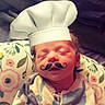 William joined the competition — help win amazing prizes! newborn, baby, infant, child, sleeping, chef_hat, costume, moustache, portrait, close_up, indoors, blanket, pillow, floral_pattern, onesie, lying_down, face, head, cute, humorous