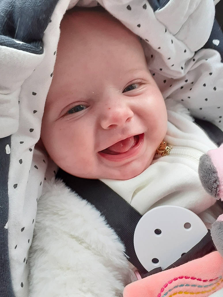 Giuliana participe au concours pour gagner de l'argent avec cette photo : baby, baby_toddler_clothing, cheek, comfort, face, facial_expression, happy, headwear, lip, mouth, nose, outerwear, person, photograph, pink, product, skin, sleeve, smile, textile