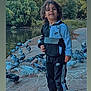 birds, boy, casualwear, child, curly_hair, daylight, footpath, greenery, happy, nature, nike, outdoor, park, pigeons, pond, smiling, standing, tracksuit, trees, water