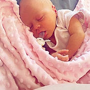 Myla-Mae is registered to the contest to win money with this photo: baby, newborn, sleeping, pacifier, blanket, pink, soft, texture, infant, resting, cute, peaceful, child, wrapped, cozy, portrait, closeup, indoor, calm, relaxation