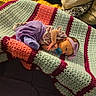 baby, bed, blanket, cozy, crochet, cushion, cute, floral_top, headband, indoor, infant, lying_down, newborn, pacifier, person, purple_clothing, resting, sleepwear, small_hands, soft_texture
