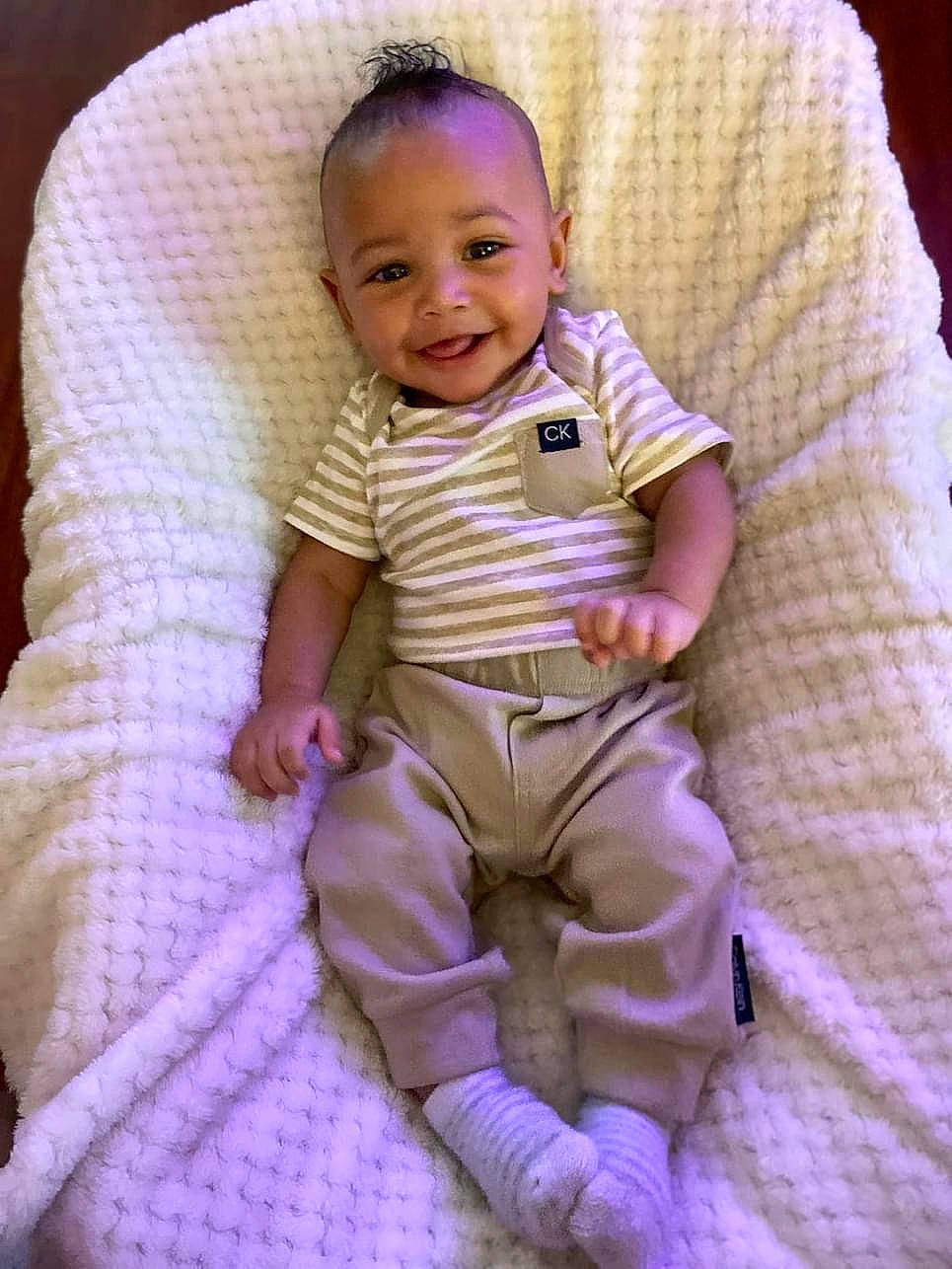 Supreme is registered to the contest to win money with this photo: baby, baby_toddler_clothing, cheek, child, comfort, eye, happy, head, human_body, iris, joy, magenta, person, pink, purple, skin, sleeve, smile, t_shirt, textile