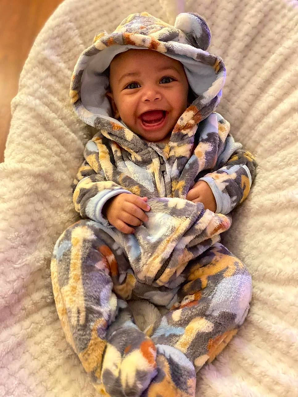 Supreme is registered to the contest to win money with this photo: baby, baby_toddler_clothing, cheek, child, comfort, eye, face, finger, fun, fur, happy, head, headgear, headwear, military_camouflage, pattern, person, skin, sleeve, toddler