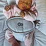 baby, infant, newborn, sleeping, pink_clothing, headwrap, bow, socks, onesie, bouncer_seat, harness, blanket, cushion, cute, peaceful, portrait, closeup, hand, feet, lips