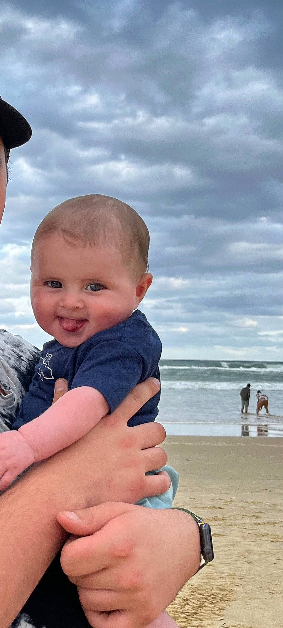 Braxton is registered to the contest to win money with this photo: azure, beach, beauty, cloud, flash_photography, fun, gesture, happy, human_body, leisure, people_in_nature, people_on_beach, person, skin, sky, smile, standing, thumb, toddler, travel