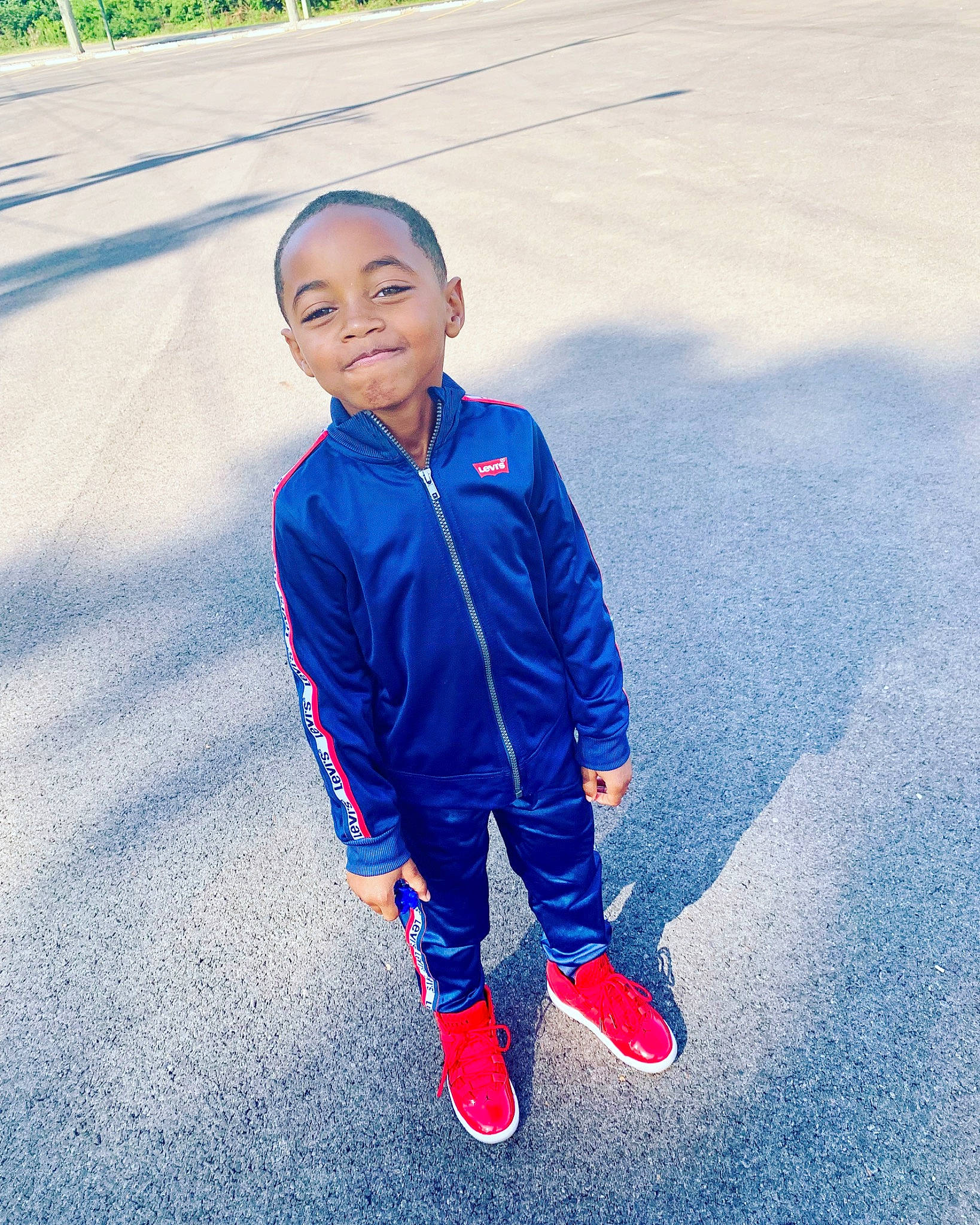 Joseph is registered to the contest to win money with this photo: blue, child, denim, electric_blue, face, footwear, fun, jacket, jeans, joy, outerwear, people, person, photography, recreation, red, shoe, smile, standing, textile