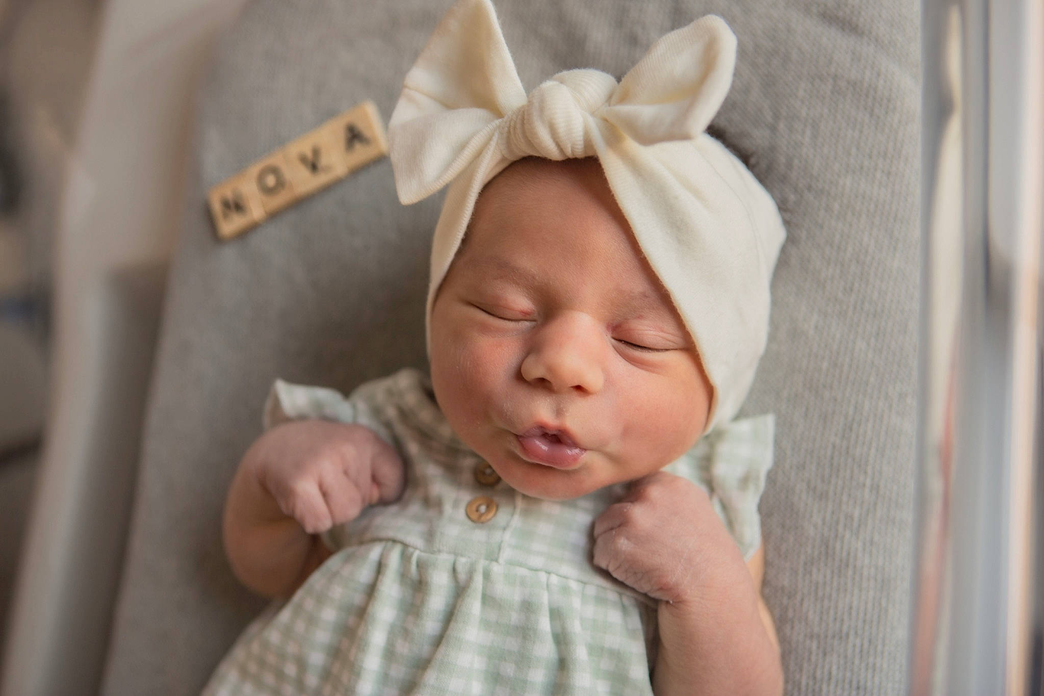 Nova is registered to the contest to win money with this photo: baby, baby_toddler_clothing, cheek, child, comfort, ear, eye, happy, head, headband, headgear, headpiece, headwear, linens, lip, person, pink, skin, sleeve, smile