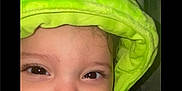 Andres is registered to the contest to win money with this photo: baby, child, smile, face, hood, green, plush, cozy, cute, infant, apparel, closeup, warm, eyelashes, skin, portrait, indoors, young, expression, person