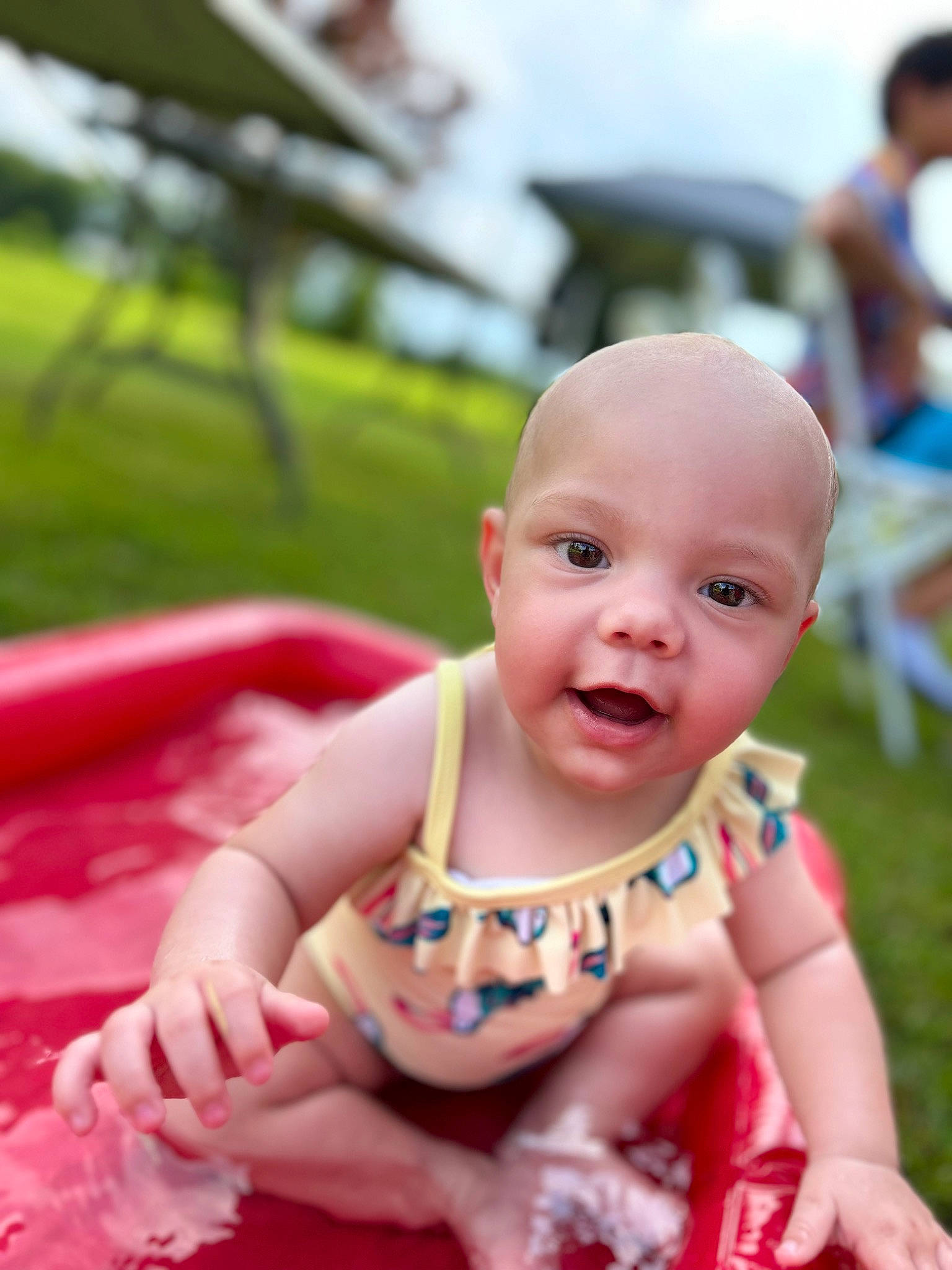 Erin is registered to the contest to win money with this photo: baby, baby_products, baby_toddler_clothing, cheek, child, dress, event, fun, grass, happy, leisure, person, pink, portrait_photography, recreation, sitting, skin, sky, smile, toddler