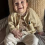 baby, child, smiling, knitwear, beige, cushion, pants, socks, face, happy, sitting, portrait, indoors, cozy, cute, person, apparel, texture, comfort, young