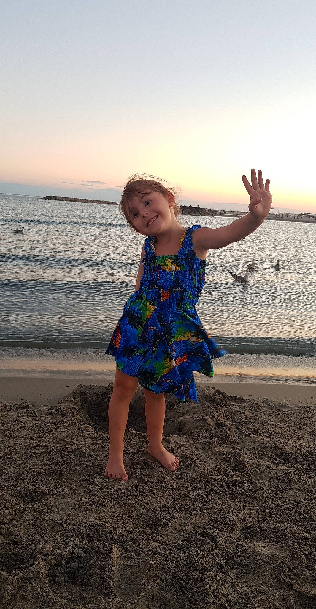 Tessa participe au concours pour gagner de l'argent avec cette photo : azure, barefoot, beach, beauty, body_of_water, dress, flash_photography, fun, gesture, happy, horizon, joy, leisure, natural_environment, people_in_nature, people_on_beach, person, sand, sky, toddler