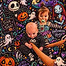 Legynd joined the competition — help win amazing prizes! baby, child, toddler, sibling, halloween, costume, skeleton_costume, striped_clothing, pacifier, smiling, portrait, indoor, colorful, pumpkins, ghosts, bats, jack_o_lantern, storybook_background, sitting, family