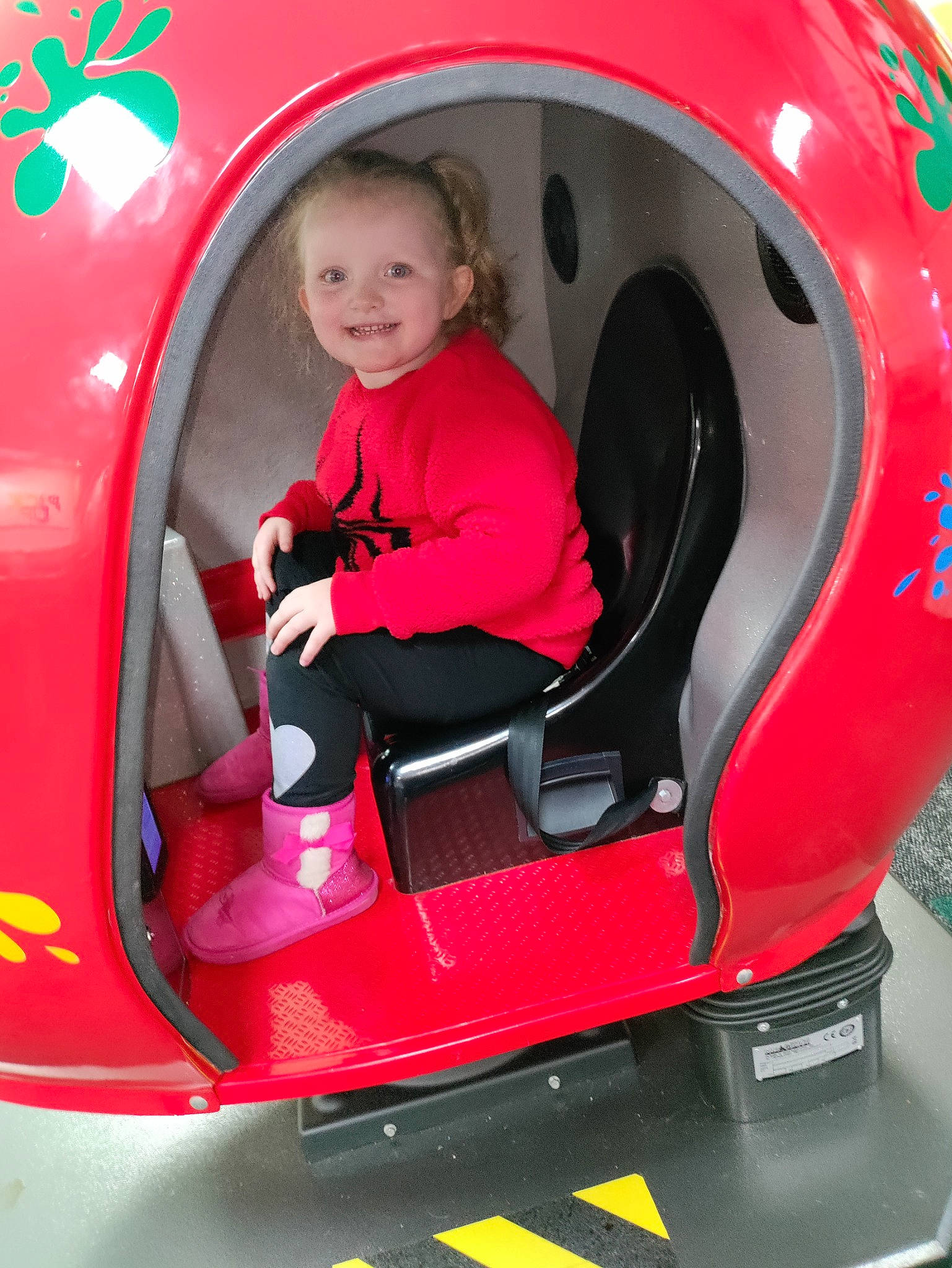 Dayona is registered to the contest to win money with this photo: auto_part, automotive_design, automotive_exterior, automotive_tire, automotive_wheel_system, baby_toddler_clothing, bumper, child, fender, fun, jacket, joy, magenta, motor_vehicle, person, recreation, red, smile, toddler, vehicle