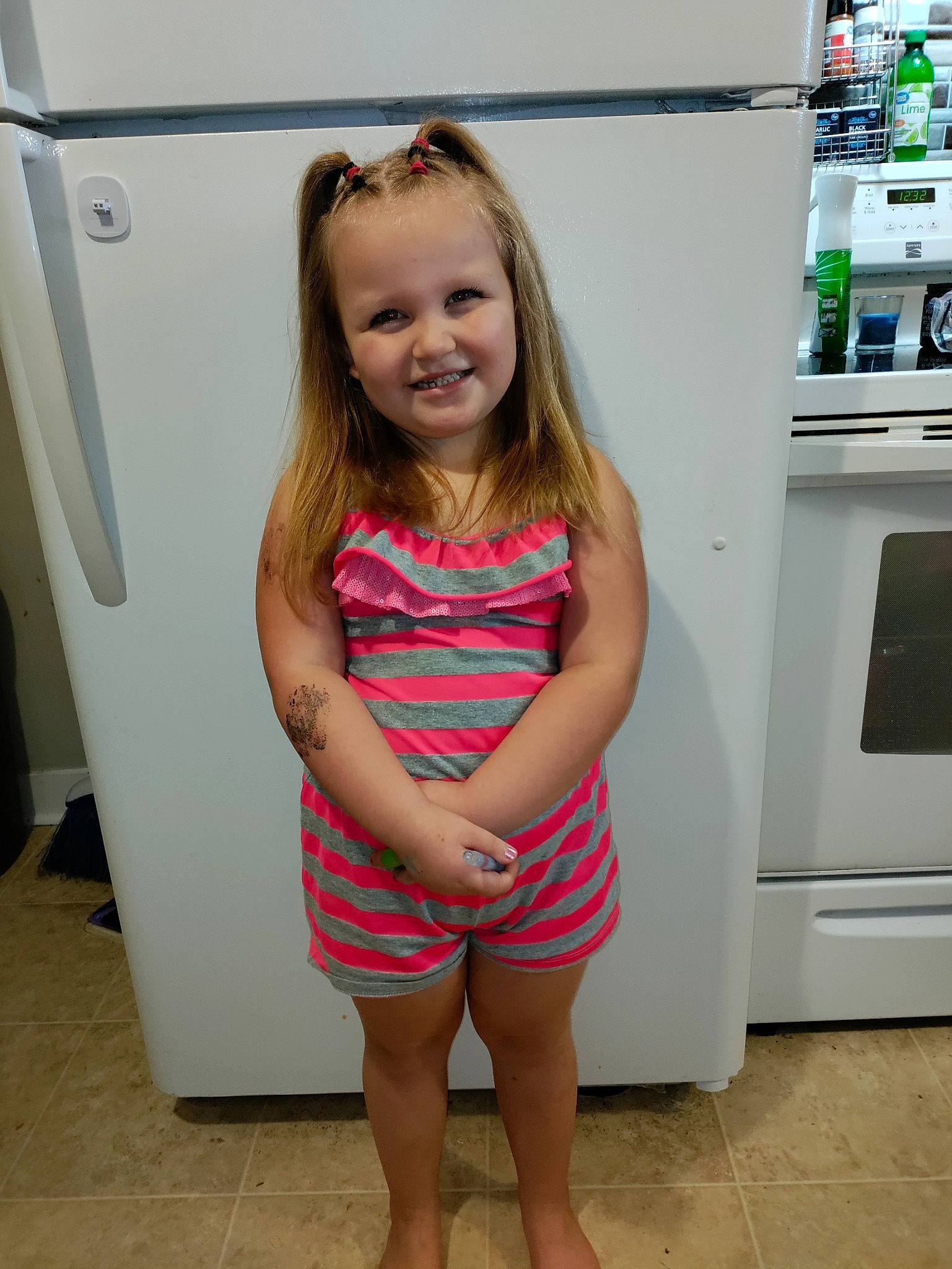 Skylynn is registered to the contest to win money with this photo: child, flooring, fun, happy, human_leg, joint, joy, kitchen_appliance, knee, leg, long_hair, major_appliance, person, photograph, shoulder, skin, smile, standing, thigh, toddler