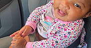 Nai Saiah is registered to the contest to win money with this photo: baby, car, car_seat, child, closeup, floral_clothing, hair_bow, hands, happy, indoor, infant, pacifier, pacifier_clip, pink_clothing, portrait, seatbelt, seated, smiling, socks, vehicle