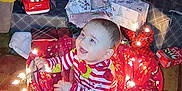 Kayson is registered to the contest to win money with this photo: baby, basket, carpet, celebration, child, christmas_lights, christmas_tree, decorations, festive, floor, gift_wrap, green, happy, holiday, indoor, pajamas, presents, red, smiling, toy