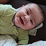 Kayson joined the competition — help win amazing prizes! baby, smiling, infant, green_onesie, lying_down, blanket, face, happy, child, cute, indoors, person, toddler, clothing, skin, head, arm, pale_skin, sleepwear, cozy