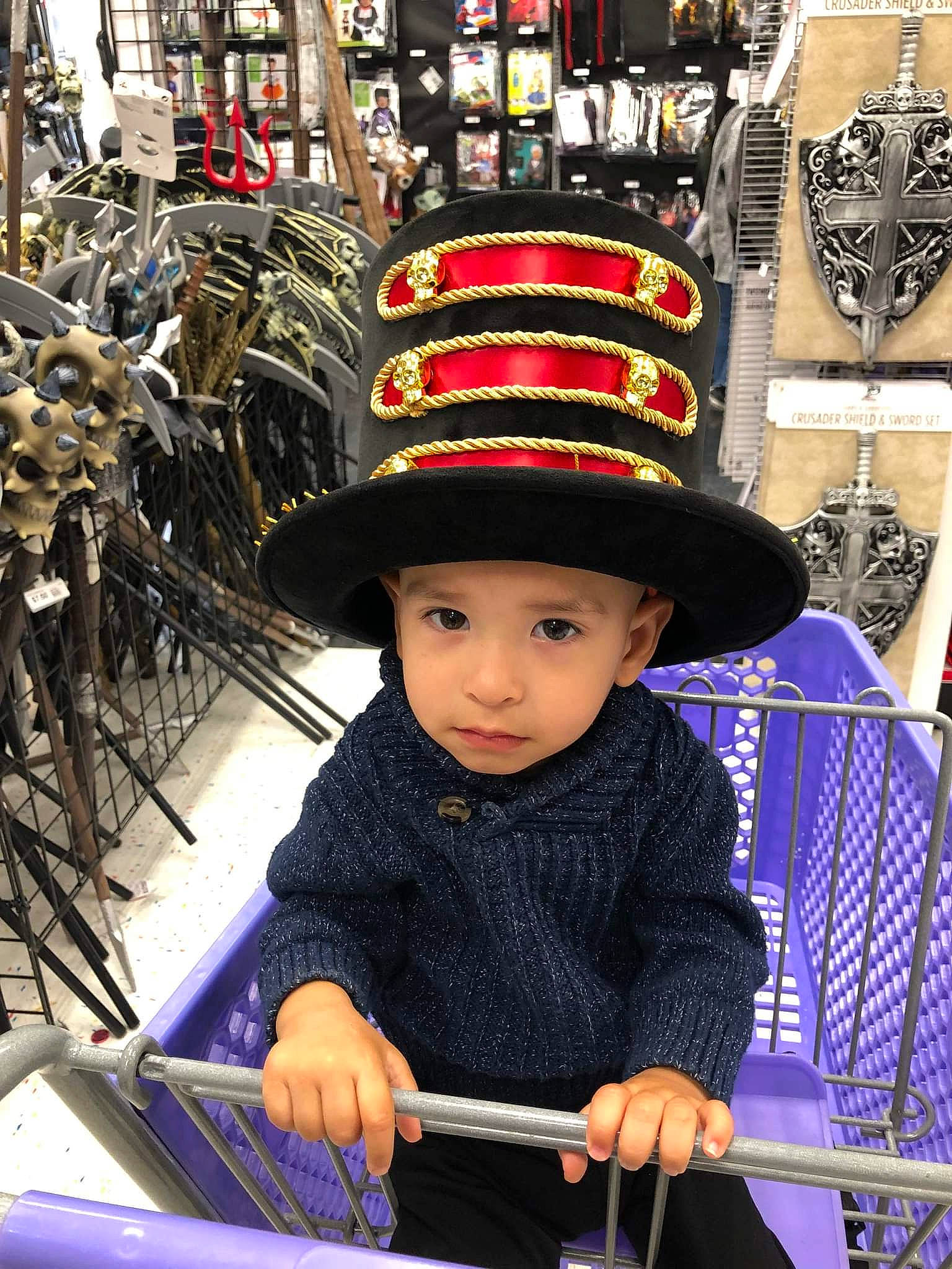 Joel is registered to the contest to win money with this photo: cap, city, costume_hat, electric_blue, event, fashion, fedora, hat, headgear, headwear, human_settlement, market, outerwear, people, person, photograph, public_space, retail, shopping, snapshot