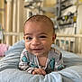 Jax is registered to the contest to win money with this photo: baby, smiling, indoor, blanket, infant, face, child, happy, lying_down, cute, soft, person, portrait, nursery, hospital, clothing, bed, young, toddler, comfort