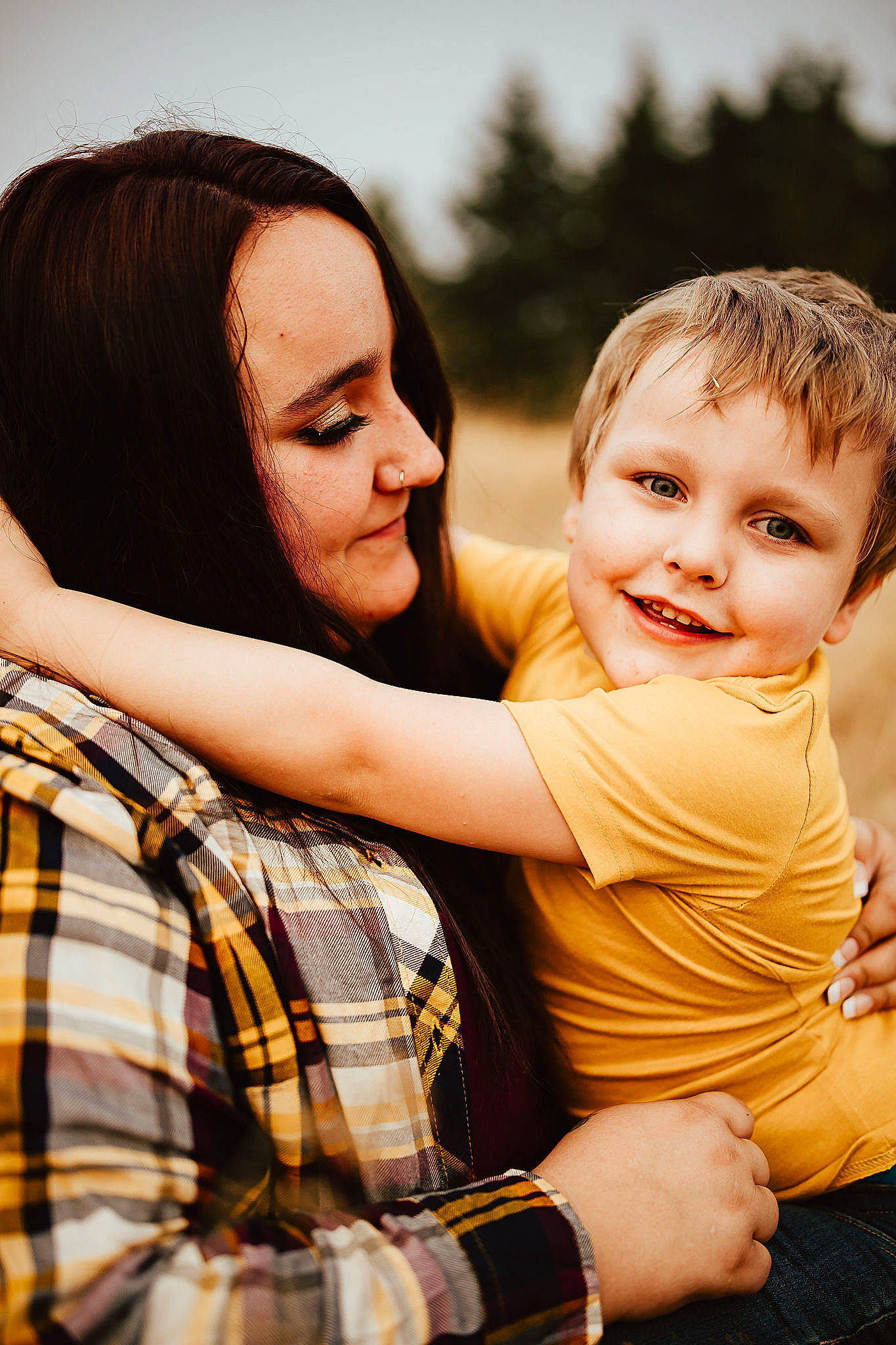 Jayden is registered to the contest to win money with this photo: event, eye, facial_expression, flash_photography, friendship, fun, gesture, grass, hairstyle, happy, human, interaction, joy, leisure, people_in_nature, person, plaid, sky, smile, sunlight