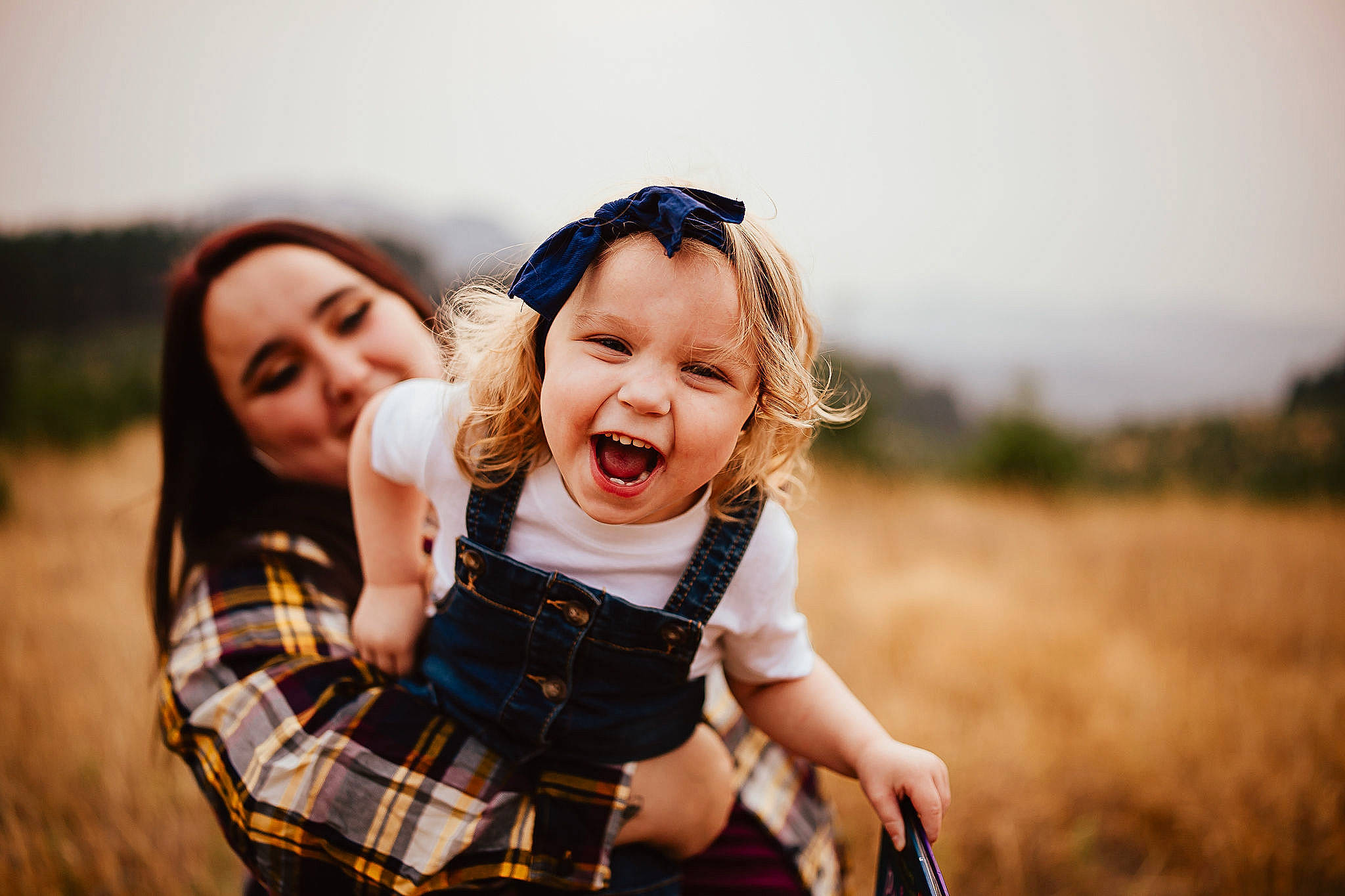 Holley joined the competition — help win amazing prizes! baby, child, event, flash_photography, fun, gesture, grass, grassland, hand, happy, joy, landscape, leisure, pattern, people_in_nature, person, plaid, sitting, sky, smile